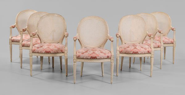 Set of Seven Louis XVI Style Armchairs: 20th century, each with carved and cream-painted frame, cane back and pink silk damask-upholstered seats, 39 x 24-1/2 x 24 in., good condition overall with surface dirt, chips and wear to frames, upho