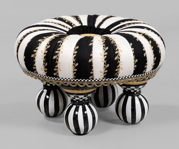 Mackenzie-Childs Upholstered Ottoman: late 20th century, tufted upholstered cushion-form seat on black, white and gold painted ceramic legs, 14 x 21 in., good condition with light surface wear Provenance: Private Collection, Blowing Rock,