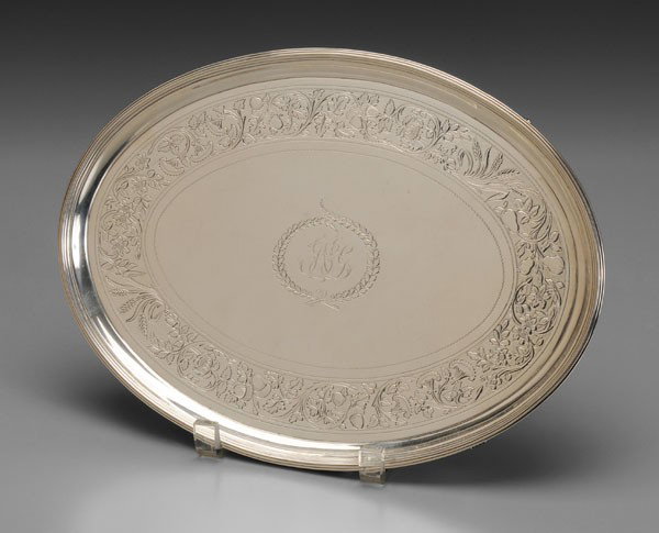 George III English Silver Salver: London, 1799, oval with scroll feet, engraved band of fruit, acorn, flowers, wheat, maker "IH" or HI", monogram, .925 fine, 21.33 oz.T., 1 x 12-1/4 x 9 in., light scratches, small dents Provenance: Pr