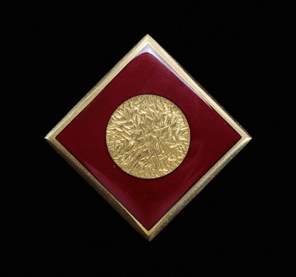 Gold and Enamel Slide/Pendant: square with raised central textured circle embellished with red enamel, 23 kt. yellow gold mount with marks for J. Kimmel & Co., 25 grams gross weight, 7/8 x 7/8 in.; insurance replacement value $4,25