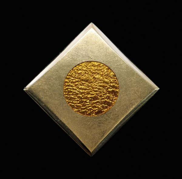 Gold and Enamel Slide/Pendant: square with recessed central circle embellished with golden [basse-taille] enamel, 23 kt. yellow gold mount with marks for J. Kimmel & Co., 21 grams gross weight, 1-3/8 x 1-3/8 in.; insurance replacem