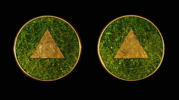 Pair Gold and Enamel Earrings: round with raised central triangle embellished with green [basse-taille] enamel, 23 kt. yellow gold mounts with marks for J. Kimmel & Co., pierced post closures, 10 grams gross weight, 9/16 in.; insur