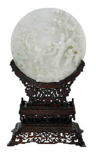 Chinese Jade or Hardstone Round Plaque Mother and Boys: with four character reign mark of the Qianlong emperor, relief carved plaque of mother in a walled garden, rocky outcroppings and flowering trees and two boys at play under clouds, 7-3/16 in.; in