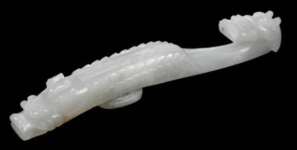 Chinese Jade or Hardstone Pale Green Dragon Belt Hook: pale color with white inclusions, dragons with scaly bodies, accession number "63.6.7a" (accessioned 1963), 5 in.Note: Tests as Jadeite on the Presidium Gem Tester II.Provenance: Charles M. Blackmon