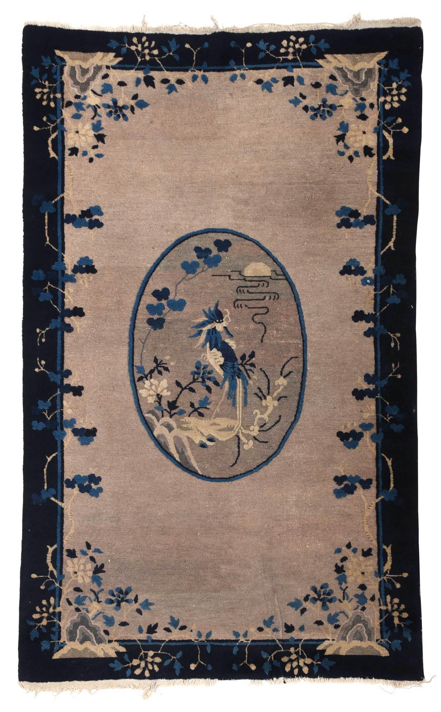 Chinese Rug: mid 20th century, medallion with phoenix, rocky outcropping with flowers, blue border, 6 ft. 9 in. x 4 ft. 1 in. Provenance: Private Collection, Raleigh, North Carolina