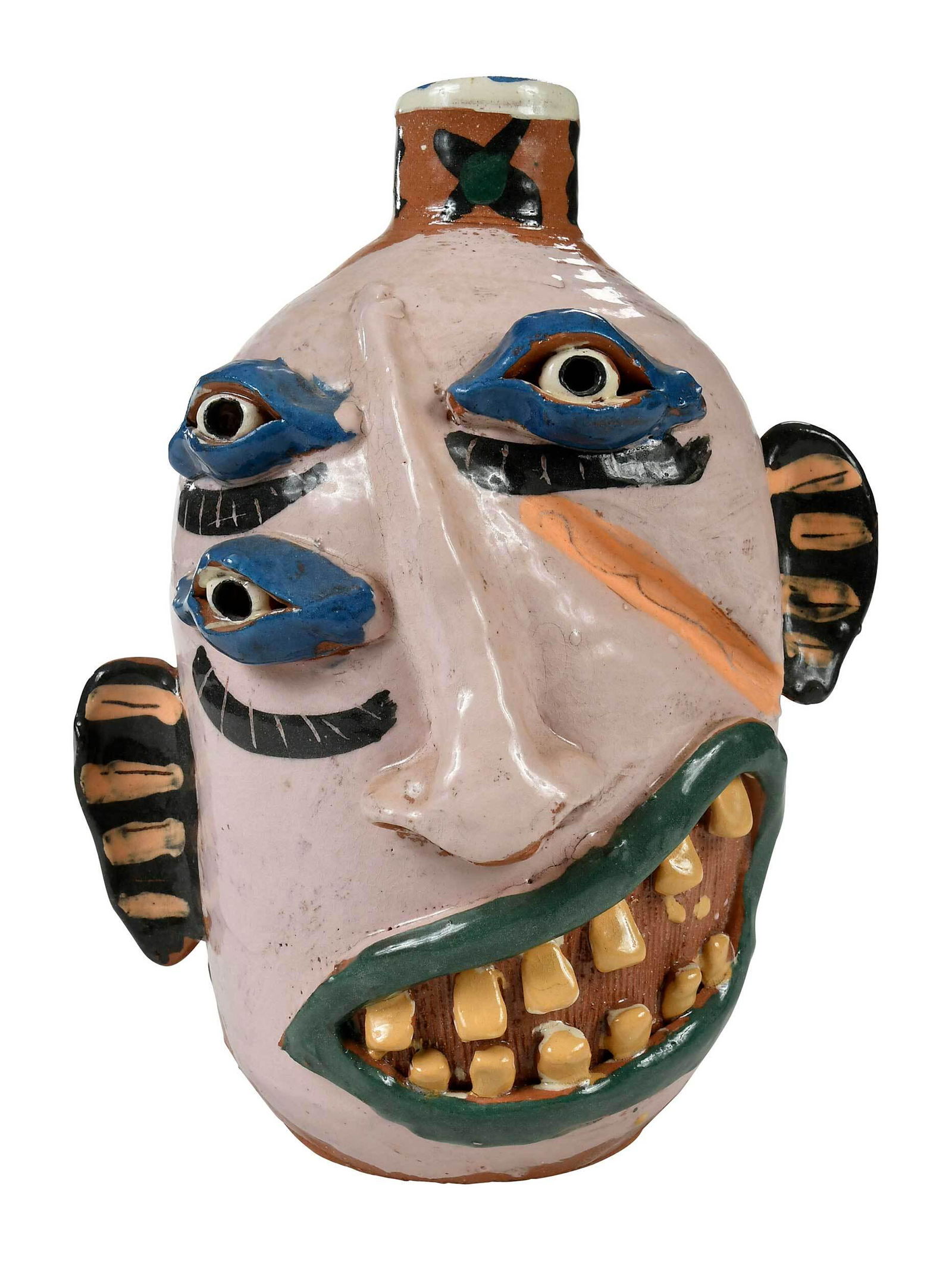 Carl Block Flatland Pottery Face Jug: Texas, 20th century, terracotta jug with single handle, three eyes, with applied ears, nose and green lips with yellow teeth, stamped with "FP" mark and dated "97" near base, and stamped with crown ma