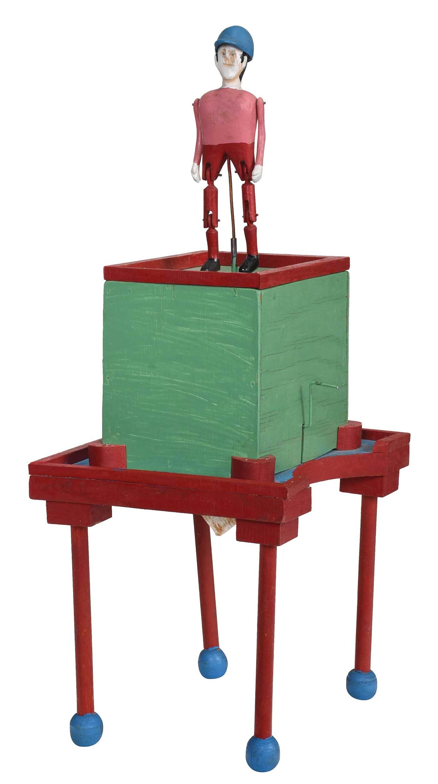 Carlton Garrett "Cloggers": (Georgia, 1900-1992) "Cloggers", mechanized box, unsigned, jockey with articulated legs, polychrome paint on wood with hand tooled motor, 22-1/2 x 9 x 10-1/2 in. Provenance: Property sold to benefit t
