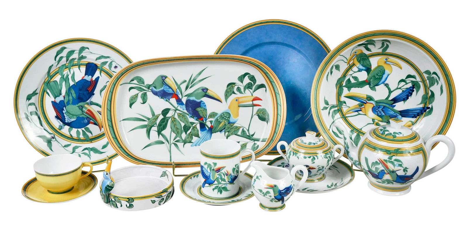 62 Piece Hermes "Toucan" Porcelain Dinner Service: 20th century, 32 pieces in the "Toucans" pattern and 30 pieces in the coordinating solid colors, each marked "Hermes Porcelaine Paris" in overglaze green to base, comprising: 11 chargers, 14 dinner pl
