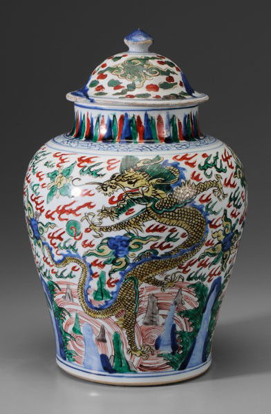 Wucai Lidded Porcelain Jar: Chinese, 17th century, baluster form, three aubergine, green and yellow dragons vigorously depicted among clouds over rocks and waves, cracked ice border at shoulder, flat base, 16 in., jar with three