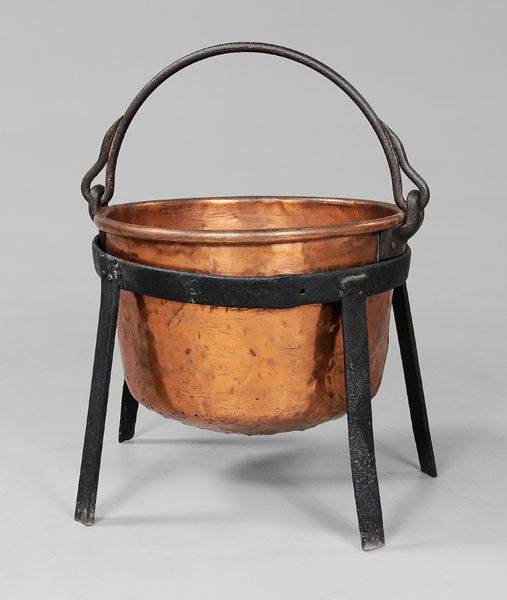 Copper Kettle With Stand: 19th century, dovetailed construction, wrought iron mounts, handle overlaps marked to resemble an animal's tail, mounts marked "2", 26 in. with handle, [old surface, extensive dents, corrosion;] with