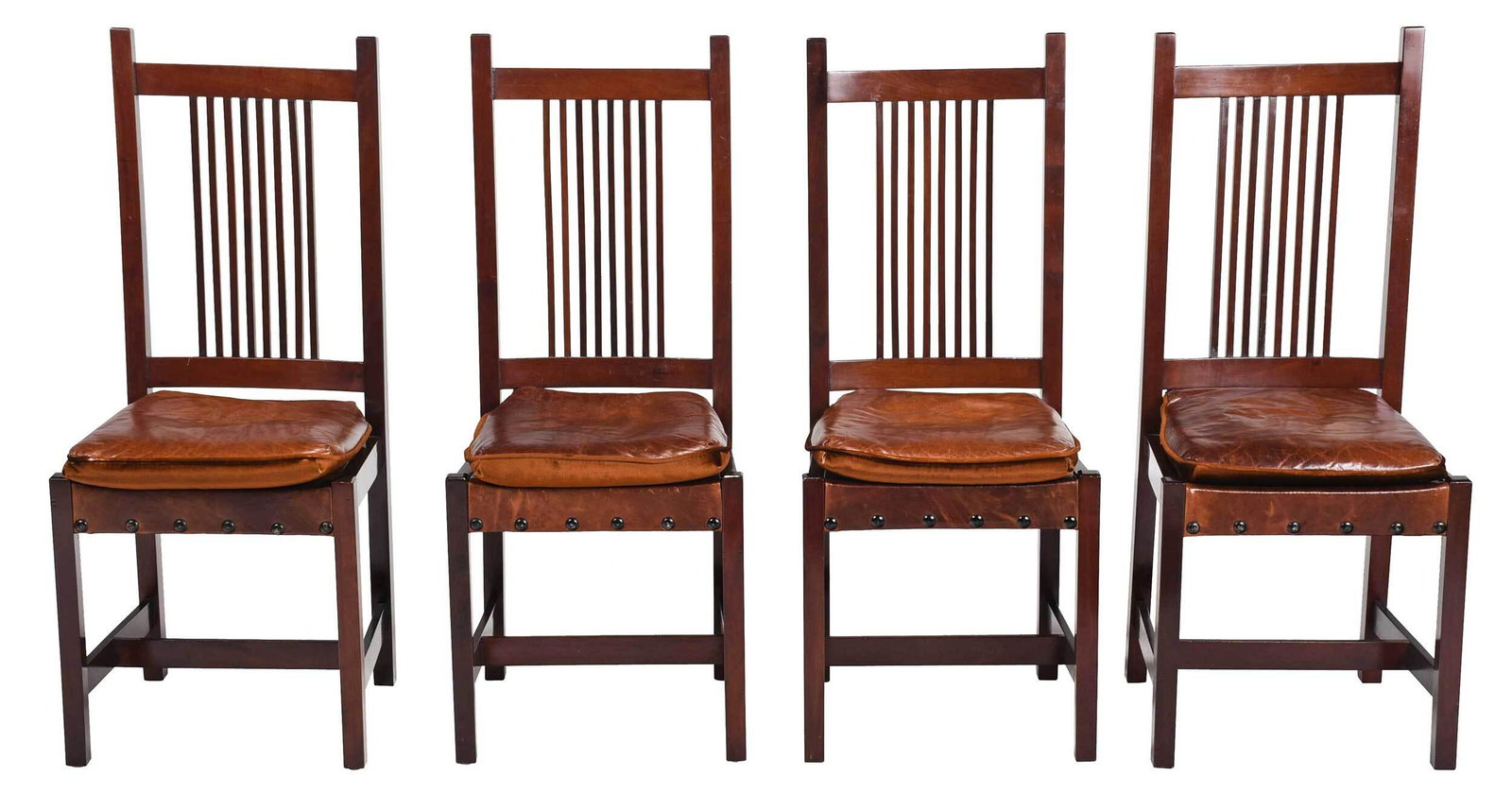 Four Arts and Crafts Mahogany and Leather Side Chairs: 20th century, mahogany throughout, each with brown leather loose seat cushion on leather support with brass tacking, 41-1/2 x 17-1/2 x 16 in. Provenance: Property from the John B. Schorsch Collection