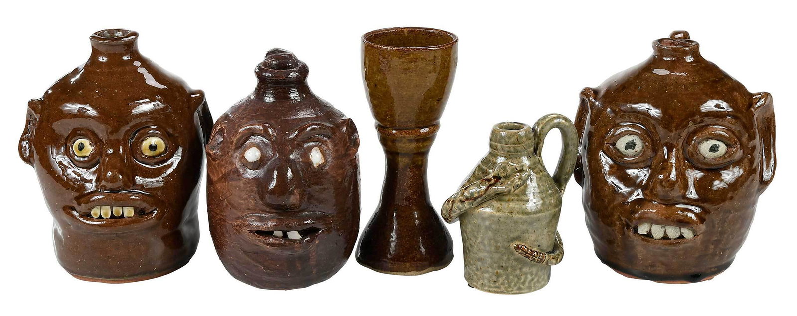 Five Pieces of Contemporary Georgia Pottery: (Reggie Meaders, White County, Georgia, 1916-2009) brown alkaline glazes, applied facial features, inset kaolin eyes, painted pupils, clay teeth, strap handles, short spouts, inscribed "REGGIE MEADERS