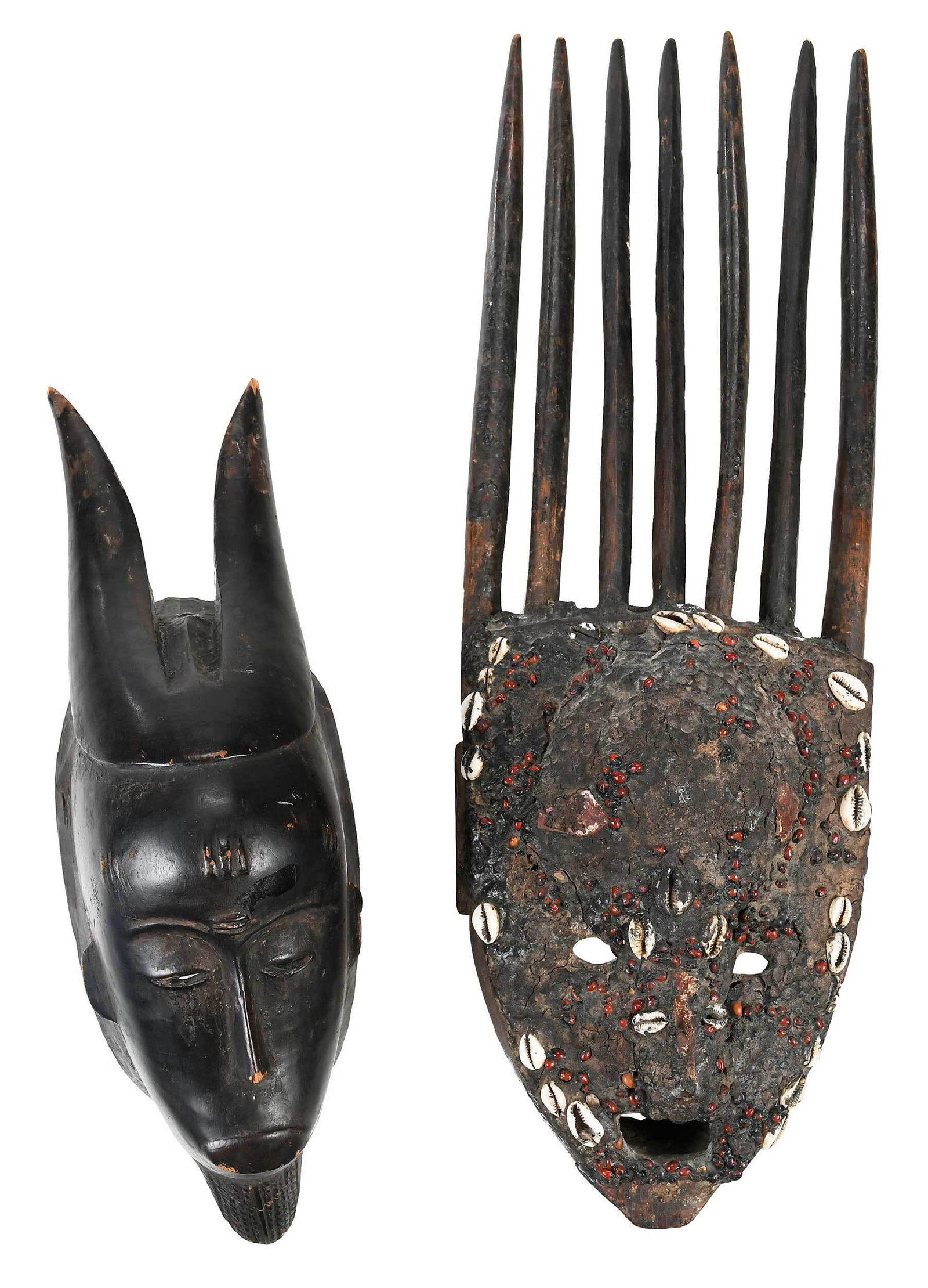 Two West African Carved Wooden Masks: Bambara Tribe, seven horned N'tomo mask with mud, cowrie shells and organic material, 25 in.; Ivory Coast, painted black Goru mask with horns, 17-1/4 in. Note: Per Consigner - Guro Mask purchased a So