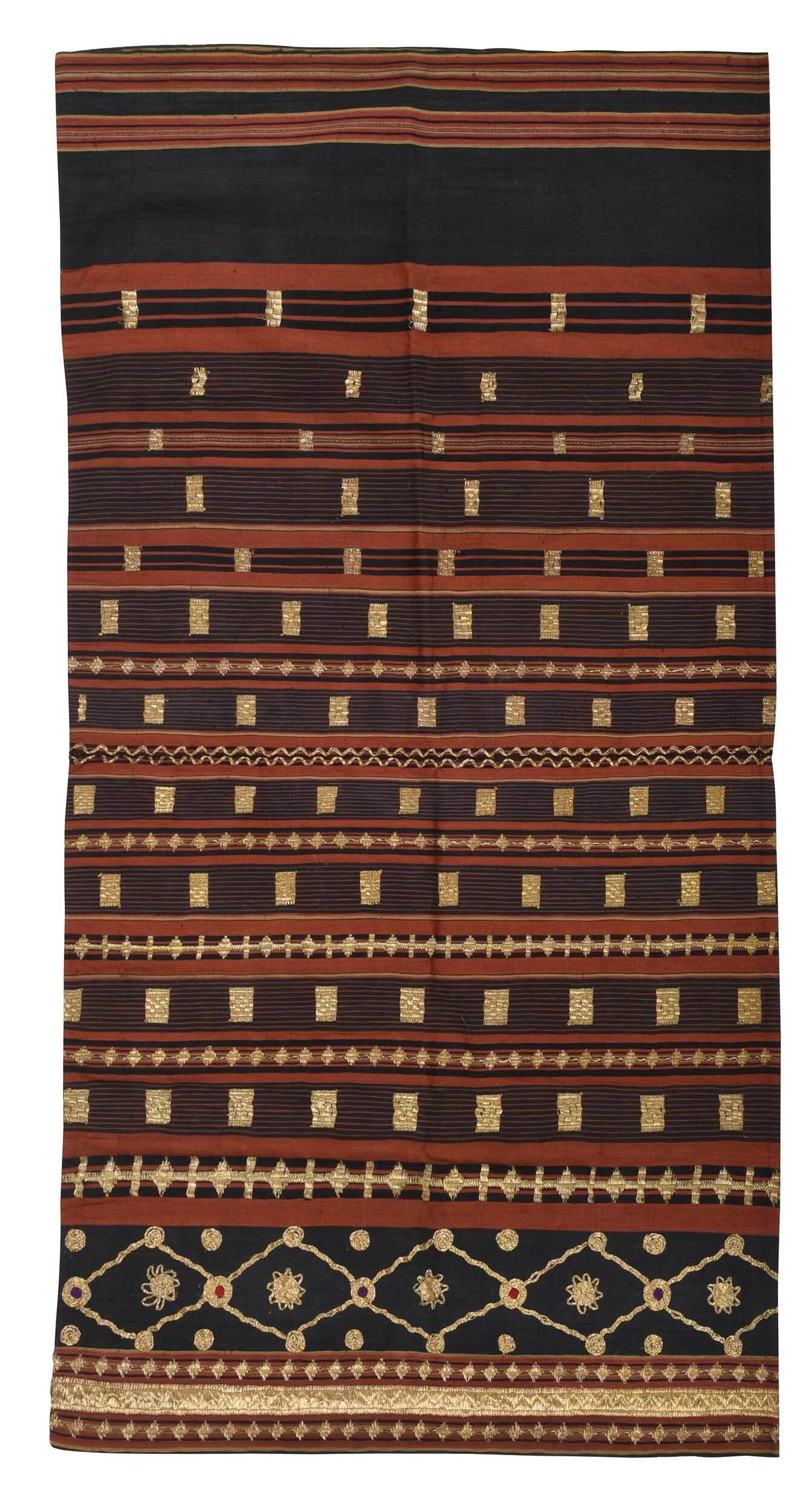 Sumatran Woven Women's Tapis Sarong: 20th century, Lampung region, dark green-gray, red, and black striped cotton ground with embroidered gold thread in geometric designs, 47-1/4 x 24-1/2 in. Provenance: Collection of Dr. Allen Grimes, L