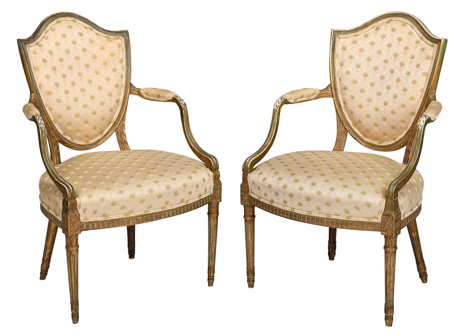 Pair George III Style Gilt and Painted Open Armchairs: 20th century, each with shield back and leaf carved shaped arms in distressed painted and gilt surface, turned and fluted legs, modern pineapple decorated upholstery, 37-1/2 x 23 x 20 in. Provenance: 