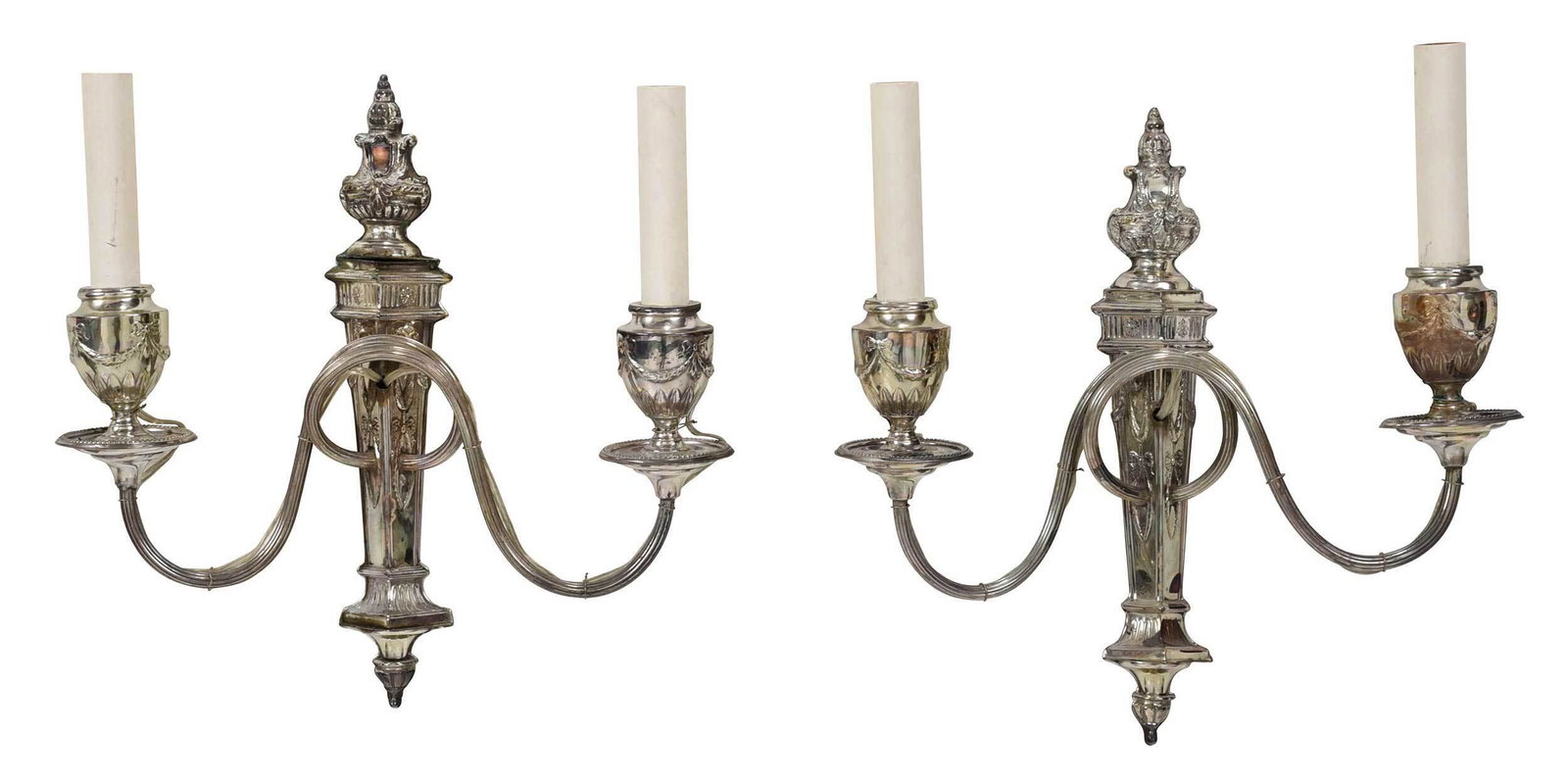 Pair of English Silver Plate Sconces: 20th century, each with neoclassical style, reeded scroll arms, urns, swags, and rams heads, each two light, no maker's mark, 12-1/2 x 12-3/4 in.; with four small lamp shades Provenance: Property from