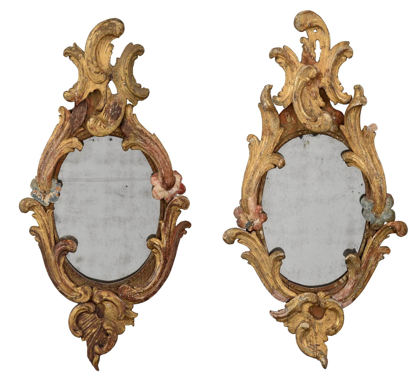 Pair Venetian Baroque Carved, Gilt, and Painted Mirrors: probably 18th century elements, each with leaf and rocaille ornaments centering an oval mirror plate, traces of polychroming, 25-1/2 x 12-1/2 in. Provenance: From the Estate of a Harvard University Pr