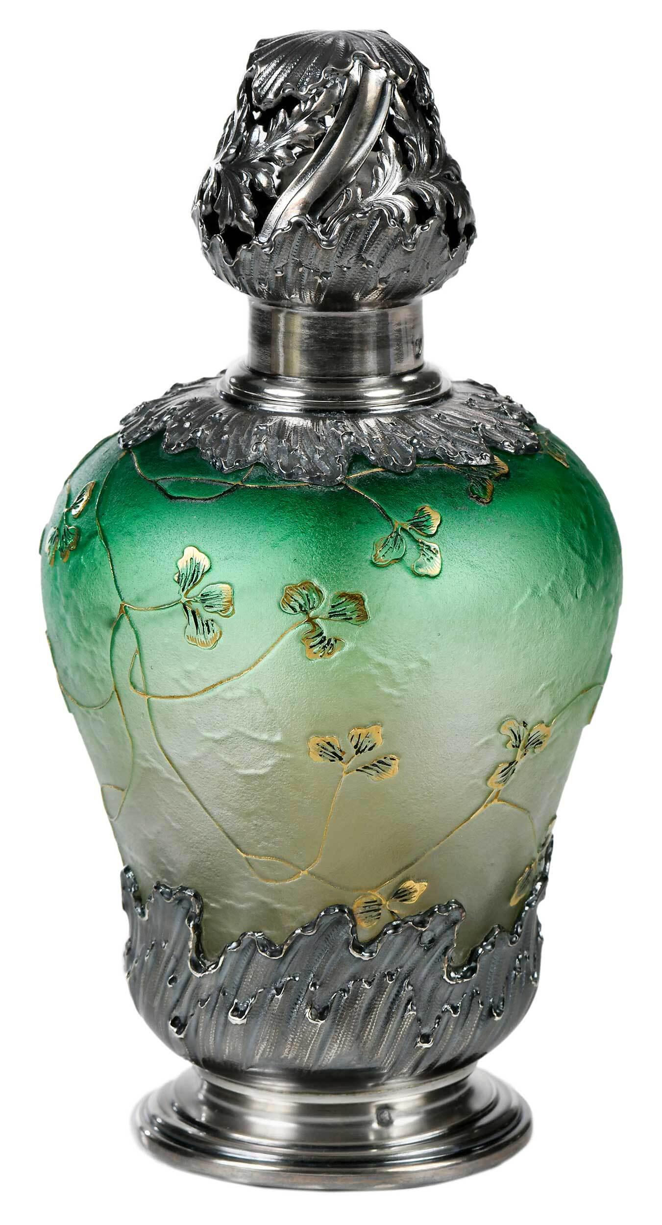 Daum Nancy Cameo Grisaille Glass Perfume Bottle: France, 1900-1910, of baluster form, gradated from pale amber to emerald green, vines and leaves in cameo grisaille with gold enameling, with unused wick and stone, French silver wave decorated mounts