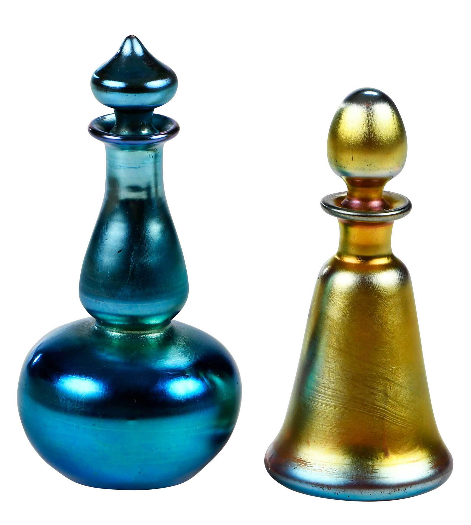 Two Steuben Aurene Glass Miniature Perfume Bottles: American, circa 1925, blue aurene, shape 6233, of bulbous form with tapered neck, pointed stopper, long dauber, signed to base "Steuben Aurene/6233", 4-1/4 in.; gold aurene of flared bell form, ovoid