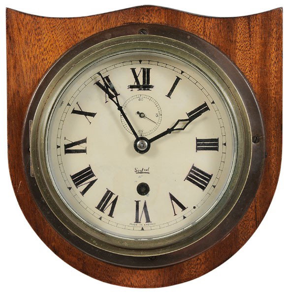 English Brass Ship's Clock: late 19th/early 20th century, face marked "Made in England" and "Scotzel", with second hand and key, 6-3/4 in. diameter; mounted on mahogany shield-shaped plaque, face probably repainted, in working o