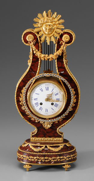 Marble, Gilt Bronze Shelf Clock: French, late 19th century, red marble lyre-form with matching base, extensive gilt bronze mounts including female face with sunburst at top, pendulum with jeweled clear glass mounts, time and strike, 
