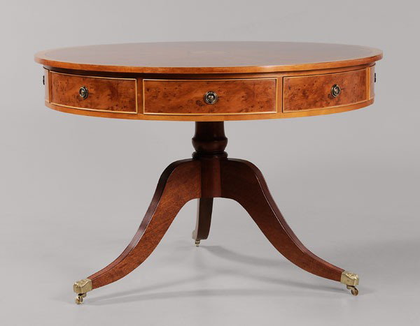 Regency Style Yew Wood Drum Table: modern construction, figured segmented veneers with fan inlay and banded edge, pedestal base with brass paw casters, eight drawers and four false drawers, 32-1/2 x 48 in., good condition with minor su