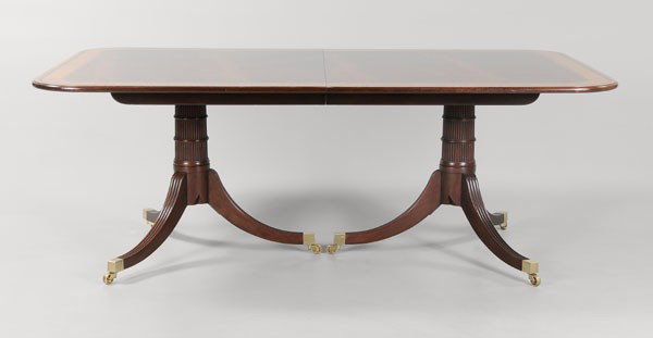 Regency Style Baker Dining Table: modern construction by Baker Furniture, figured mahogany veneers with light wood banding, two pedestals, with three matching leaves in original carton, 29 x 78 (opens to 135 in.) x 48 in. excellent co