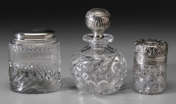 Three Sterling and Cut Glass Dresser: Jars, one with sterling stopper, marks for Tiffany & Co., inscription, 6-3/4 in.; one with English silver hinged top, gilt interior, marks for J. Cook & Sons, Birmingham, 1891, inscription, 4 x 2-3/4