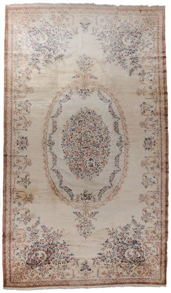 Aubusson Style Hand-Woven Carpet: probably Indian, mid 20th century, finely hand woven with oval central medallion on an ivory and beige ground, floral swag borders, 11 ft. 5 in. x 23 ft. 6 in., even high pile, scattered furniture imp