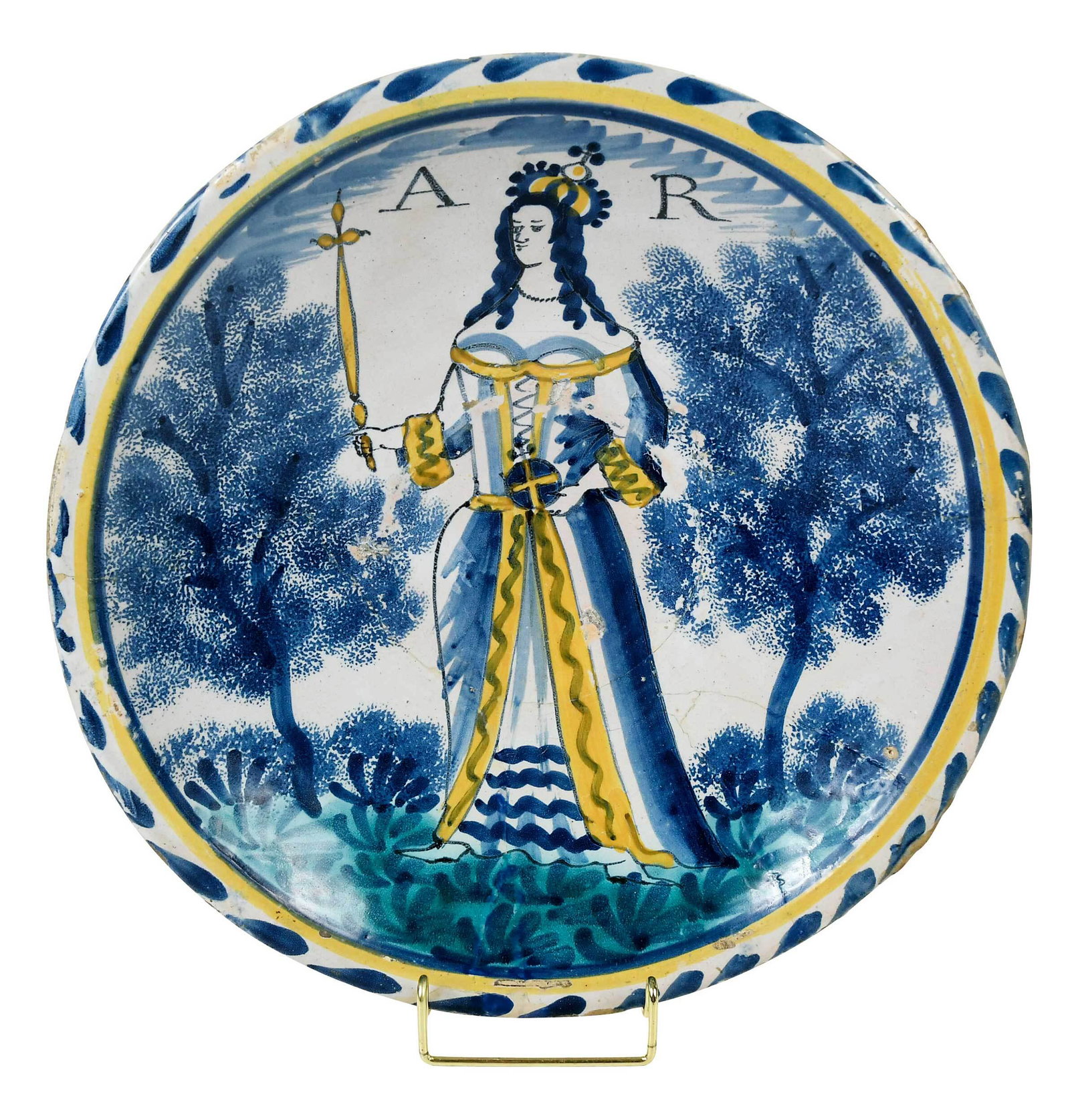 London Delftware 'Queen Anne' Royal Portrait Charger: possibly Norfolk House, circa 1702-14, painted full length Queen Anne wearing coronation robes with crown, orb and scepter in yellow accents, flanked by her initials "AR", blue sponged trees, standing