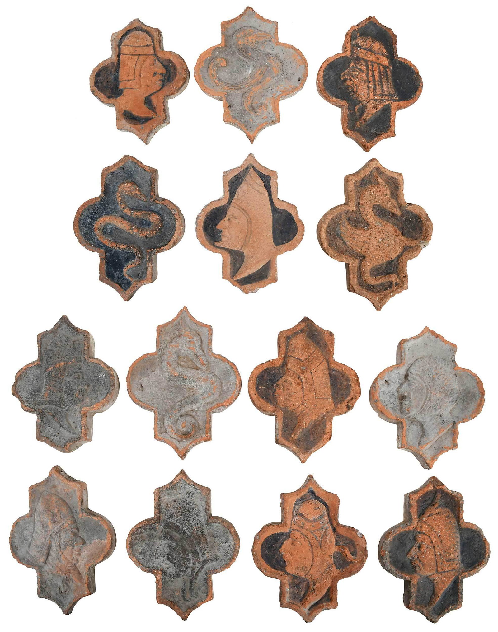 14 Early French Terracotta Molded Tiles: of stylized cruciform, depicting various birds, snakes, and profile busts, some with blackened background, numbered to reverse, 7 x 5-3/8 in. Provenance: Private Collection