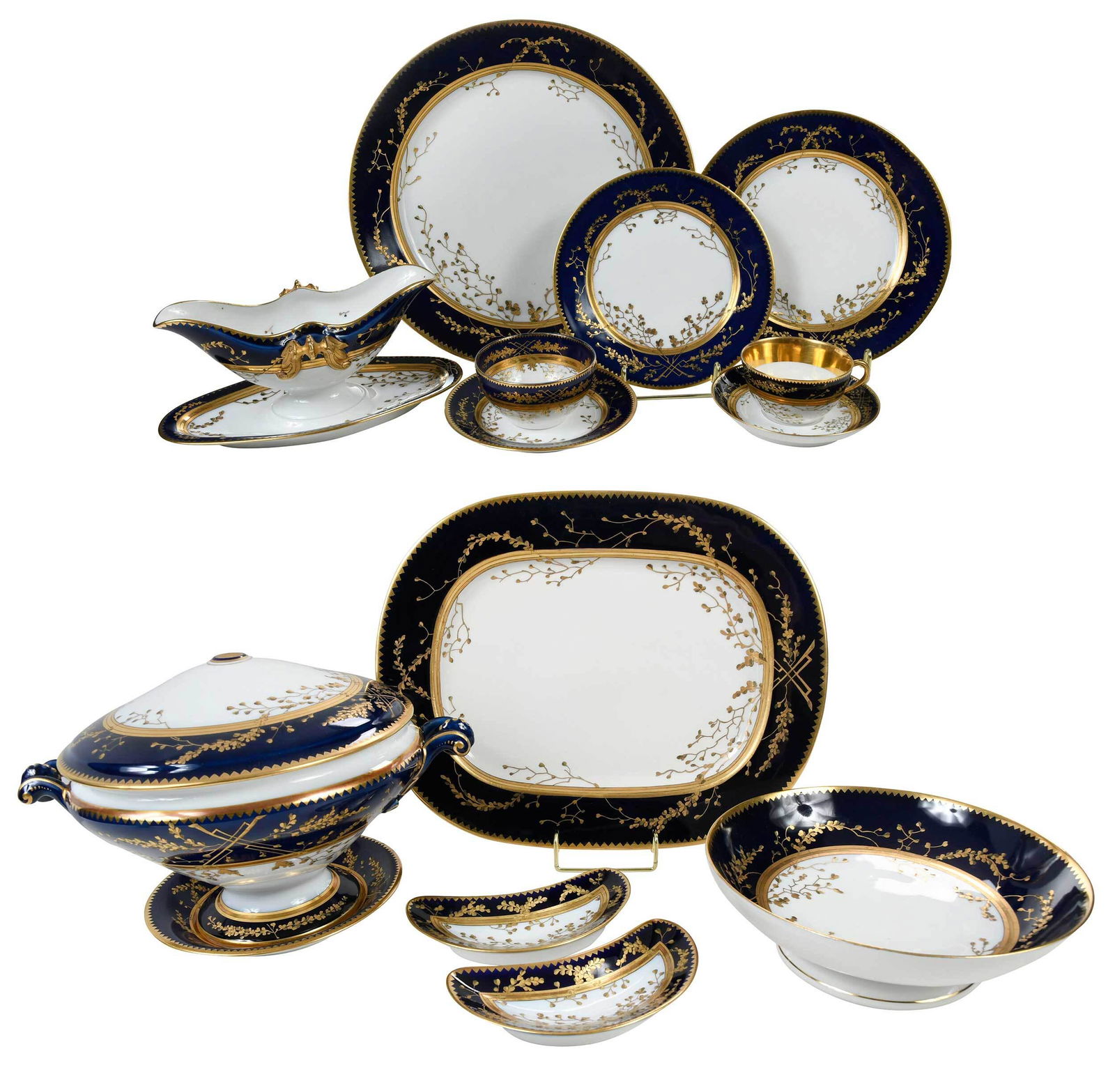 83 Piece Assembled Porcelain Dinner Service: Czech and Austrian, late 19th/early 20th century, decorated in gilding with branches of leaves and berries on a cobalt ground within a gilt dentil edged rim, comprising: 30 dinner plates impressed "TK