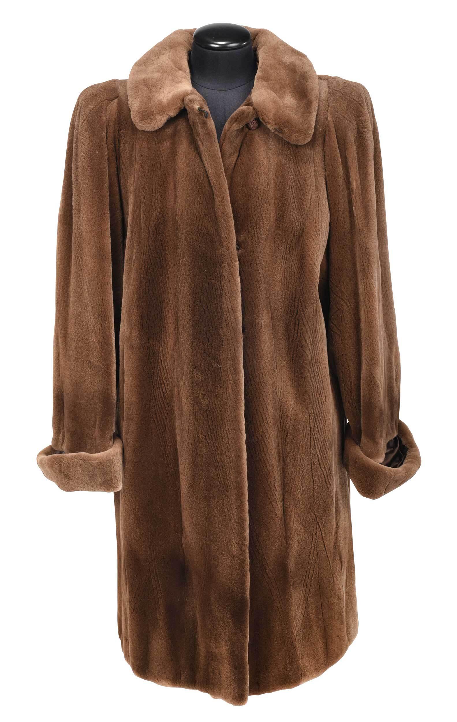 Car Length Sheared Mink Coat: 20th century, Peter Pan collar, single button closure to neck, three hook closures, slit side pockets, interior brown lining, cuffed, label for "Simes Grigos/New York", shoulder 18 in. sleeve 24-1/2 i