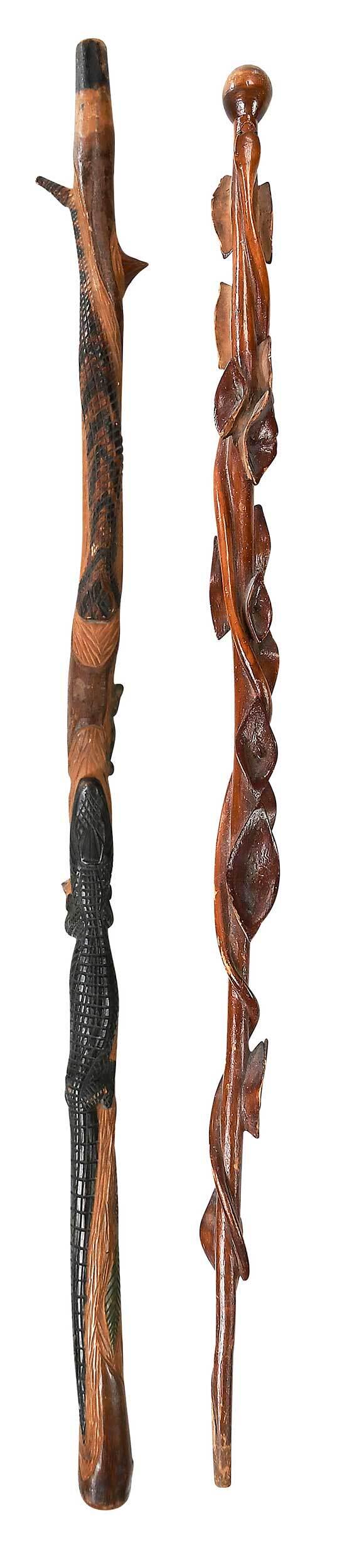 Two Carved Figural Walking Sticks: early 20th century, the longer carved in high relief with polychrome alligator, snake, frog, foliage, possibly laurel or rhododendron, 35-1/4 in.; together with a ball head stick carved with a twining