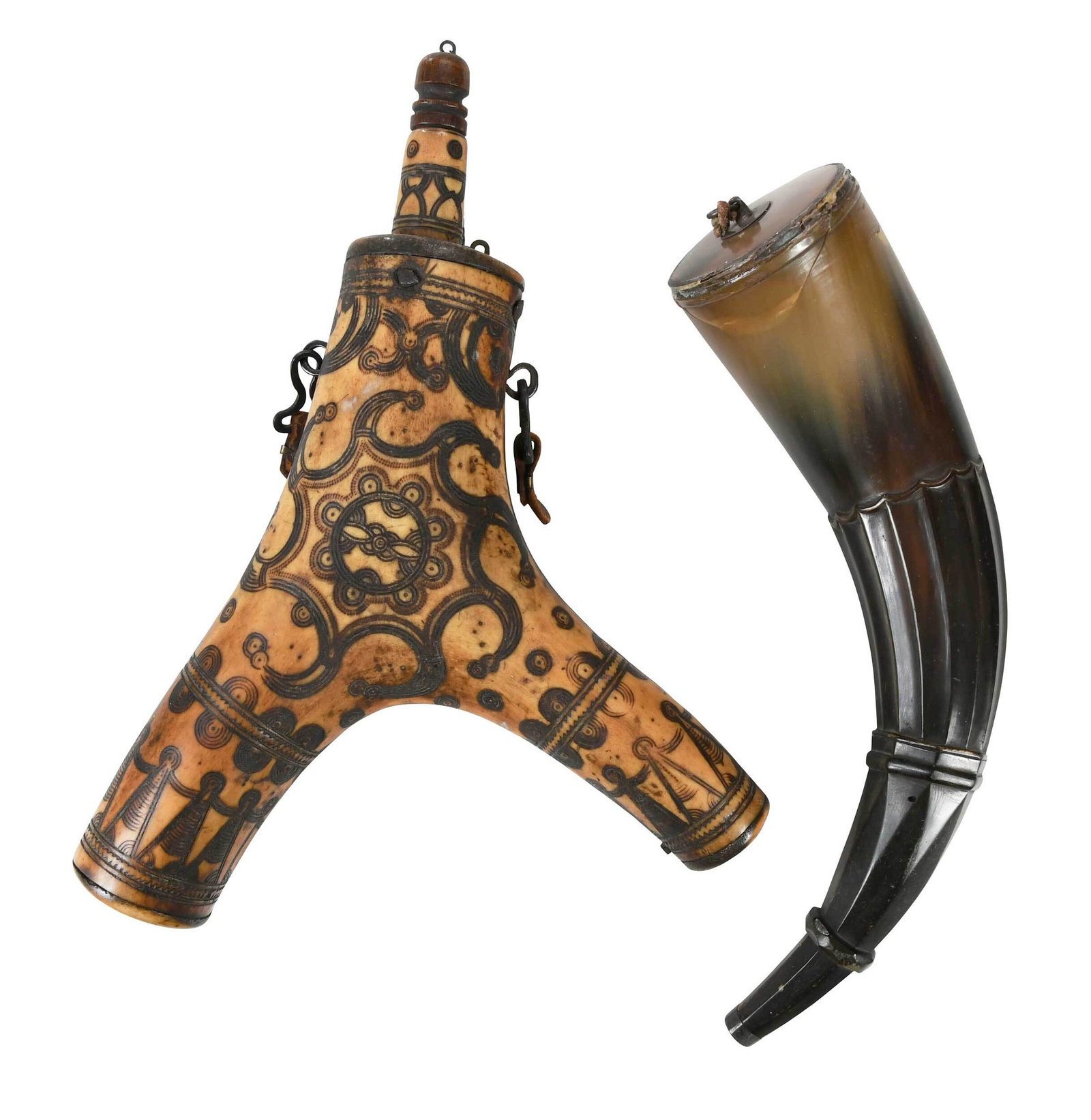 Two Horn Powder Flasks: 18th/19th century, comprising Y shaped horn flask with scrimshaw design, wood plug with chain attachment, two lanyard hooks with leather loops, 11 in.; horn flask with carved bevel design, two metal l