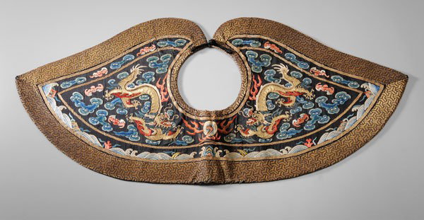 Silk-Embroidered Collar: Chinese, 19th century, silk and metallic thread embroidered confronting dragons with pearl among clouds and bats, border of metallic thread Y-pattern brocade, verso with red silk brocade of flowering 