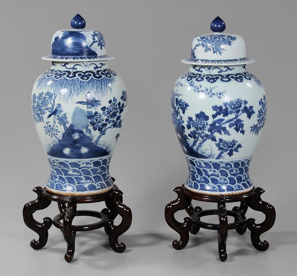 Pair Blue and White Floor Vases: Chinese, porcelain, lidded balusters, birds among trees and rock formations, borders of [ruyi-]heads and waves, 35 in., 47 in. on stands, minor accretion, otherwise excellent condition; one stand with