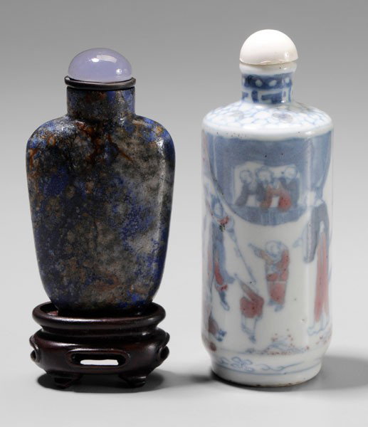 Two Snuff Bottles: Chinese, 18th/19th century: one spade-form [lapis lazuli,] natural stone stopper, 2-3/4 in., with wood stand, [minor rim chip in matrix, later stopper;] one cylindrical porcelain, blue and white with 