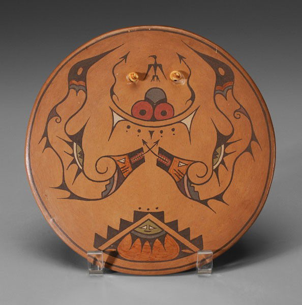 Santa Clara Plaque: Southwestern United States, mid 20th century, earthenware with slip decoration with two [avanyu,] marked on back "Lela" (Lela Guttierrez), presentation label verso dated 1945, 8-1/2 in., leather hange