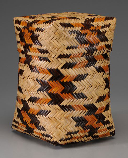 Rowena Bradley Cherokee Basket: (North Carolina, 1922-2003), double-woven river cane with lid, geometric decoration in two colors, probably walnut and bloodroot dyes, 13-1/2 in., with original Qualla tag dated July 4, 1976, and with