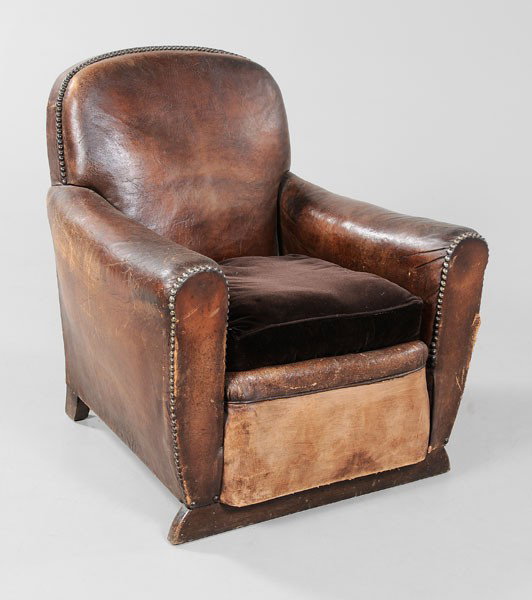 Art Deco Leather Club Chair: French, early 20th century, dark brown leather set with brass studs and velvet-covered loose cushion, 31-1/2 x 33 x 34 in., cushion recovered, scattered wear, abrasions, cracking and minor tears to le