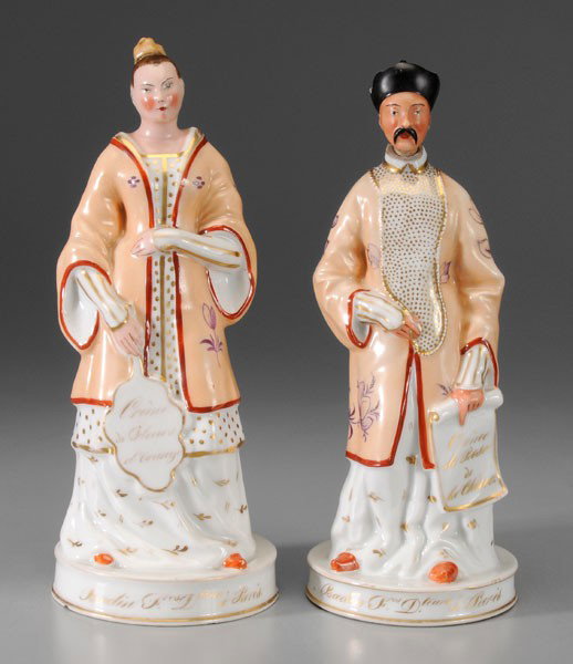 Pair Old Paris Cologne Bottles: French, second quarter 19th century, Asian figures with stoppers, gentleman holding scroll marked [Crème de Rose de la Chine,] female holding a fan marked [Crème de fleurs d'orange,] other marks for