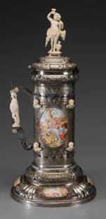 Monumental Continental Gilt Silver: Stein, engraved shells, urn, acanthus and scroll decoration, applied enamel panels with cupids and musical scenes, ivory cupids, figure with grapes and urn, soldier handle, bands with cabochon lapis