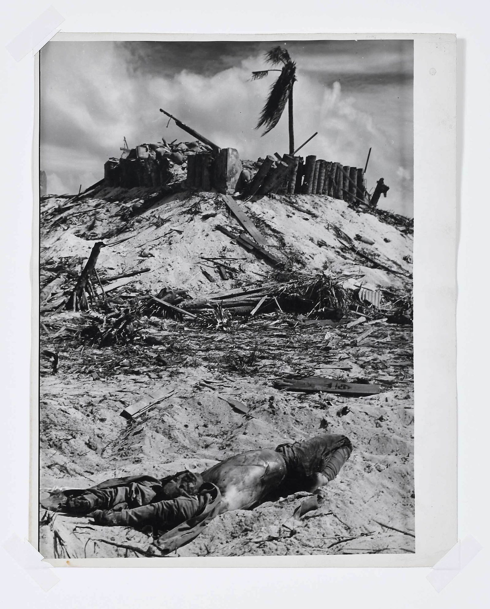 W. Eugene Smith: (1918-1978) The Vanquished on Tarawa, titled, artist stamp verso, collection stamp verso, gelatin silver print, sheet 14 x 11 in., matted not framed, mat 20 x 16 in. Provenance: Private Collection, Wi