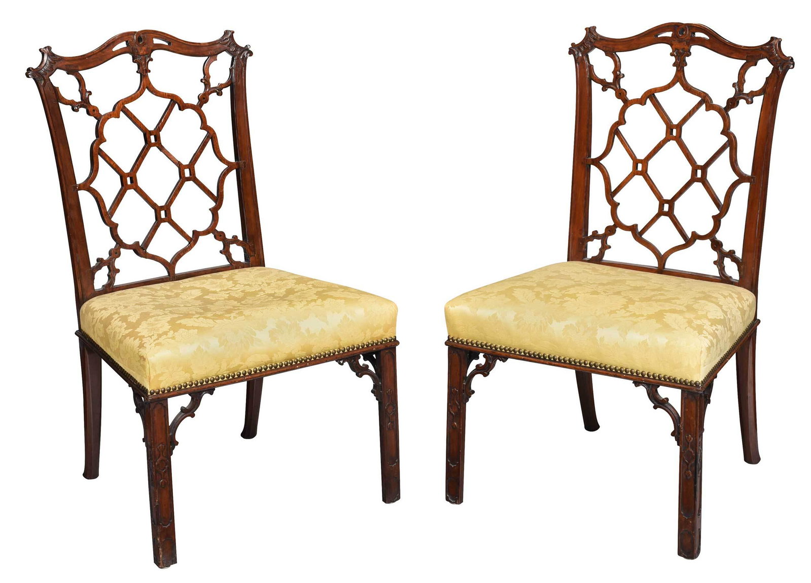 Pair Chinese Chippendale Style Mahogany Side Chairs: British, early 20th century, each with pierced and carved crest over laminated openwork back, blind fretwork legs, yellow damask upholstered slip seats, 37-1/2 x 22 x 21-1/2 in. Provenance: Estate of 