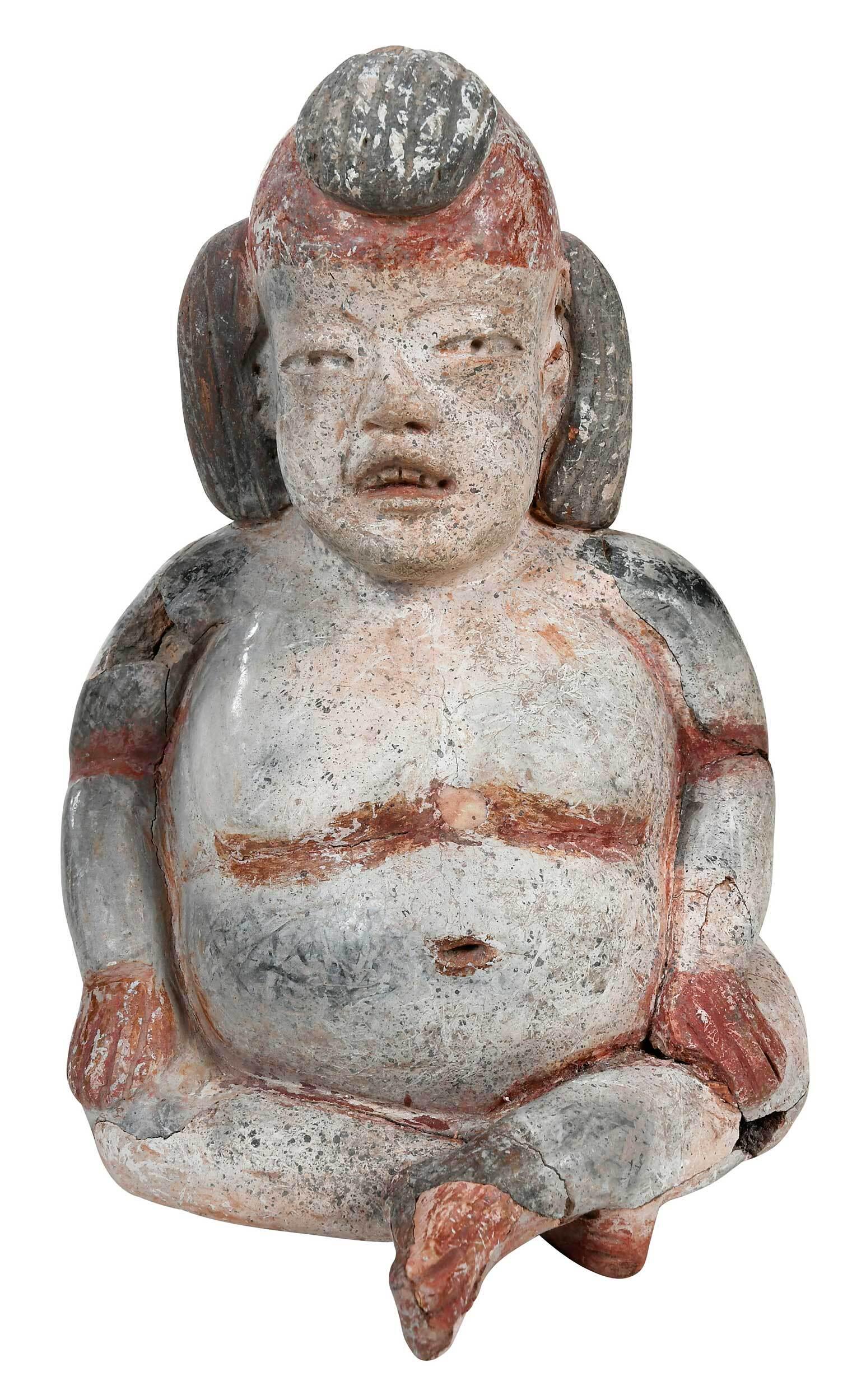 Mexican Olmec Style Rotund Hollow Seated Figure: earthenware painted in red, white, and black pigment, with striated topknot and bun, 8 in. Provenance: Merrin Gallery, New York, 1990; David Bramhall, New York; Private Collection, New York