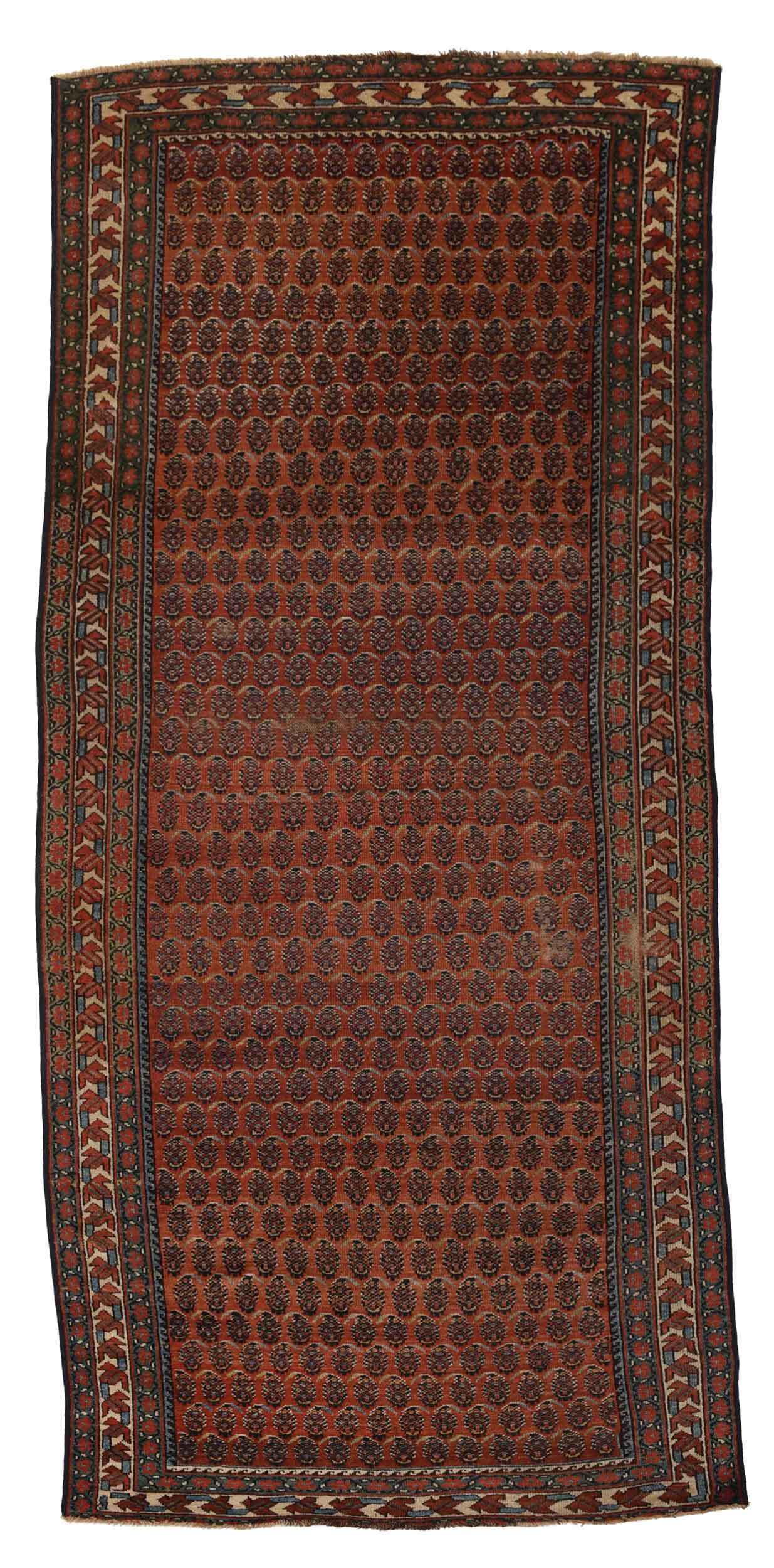 Kurdish Runner: early 20th century, red field with repeating rows of stylized boteh, white border with geometric trailing leaf design, 4 ft. 4 in. x 10 ft. Provenance: Property from the Estate of Gerald J. and Rosali