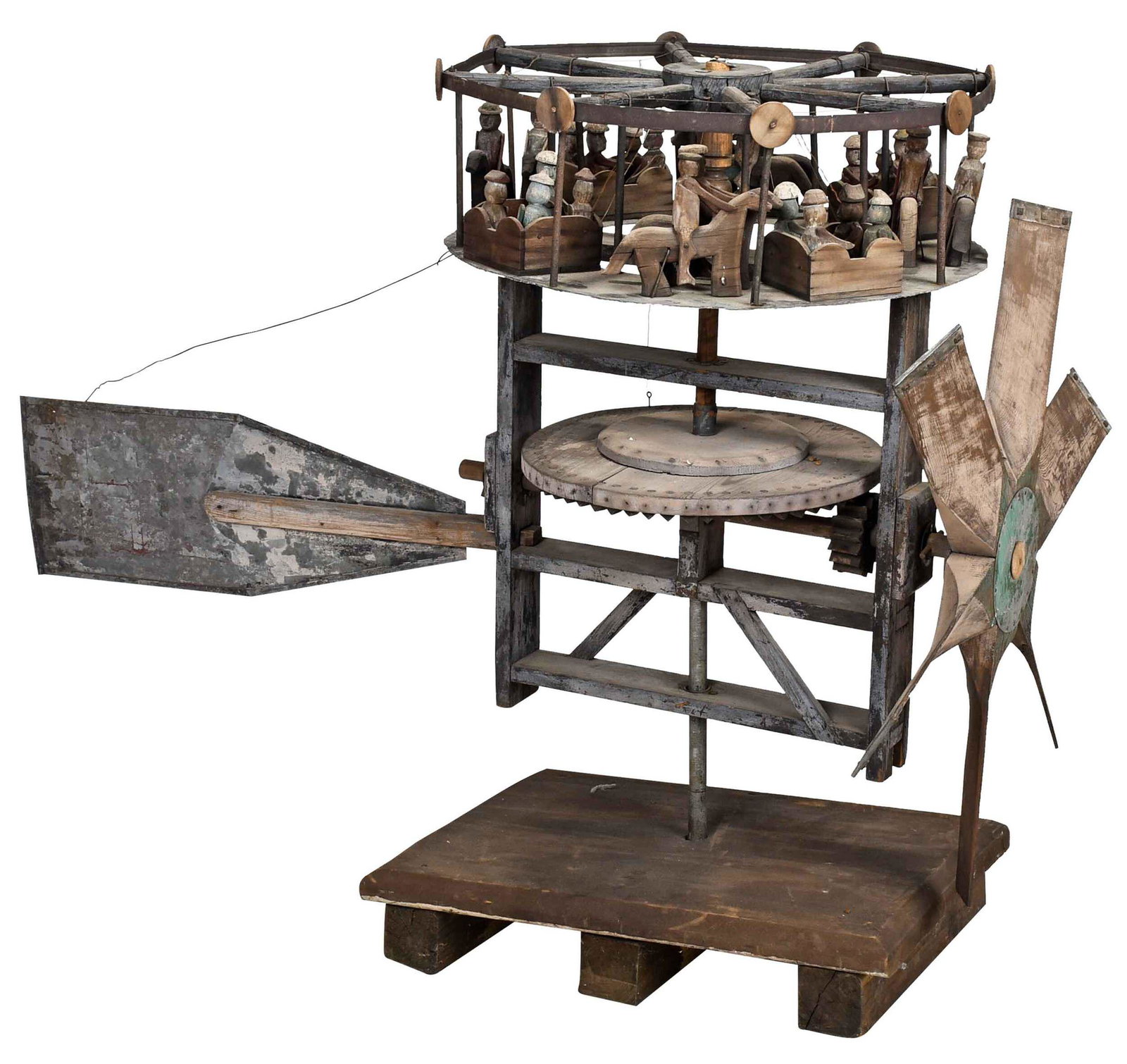 Large Vintage Painted Folk Art Carousel Whirligig: late 19th/early 20th century, top merry go round form with multiple figures, some on horseback, with large fan and wheel mechanism, tin tail fin with traces of red paint and lettering "HL", traces of 