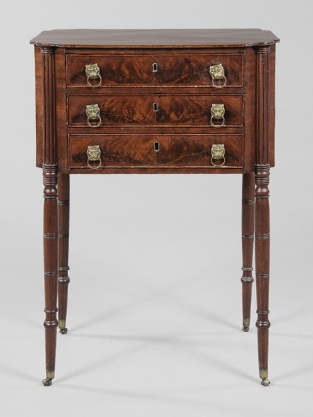 Fine New England Sheraton Work Table: Massachusetts or New Hampshire, early 19th century, figured mahogany veneers with white pine secondary, three dovetailed drawers, turned legs with original brass casters, 30-1/4 x 21 x 16 in., top dra