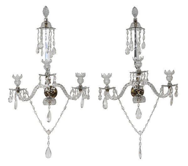 Pair Brass and Cut Glass Wall Sconces: British, 19th century, each with central obelisk supporting single pineapple finial above three arched arms with urn-shaped sockets, hung with swags, prisms and cut glass pendants, 28 in., one obelisk
